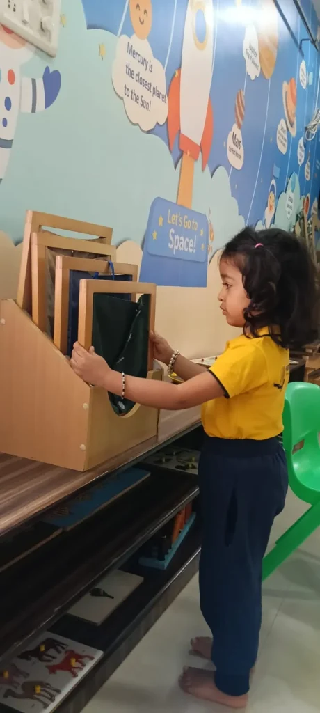 Child working with sensorial material at ACE Montessori, Padmanabhanagar and Jayanagar, Bangalore