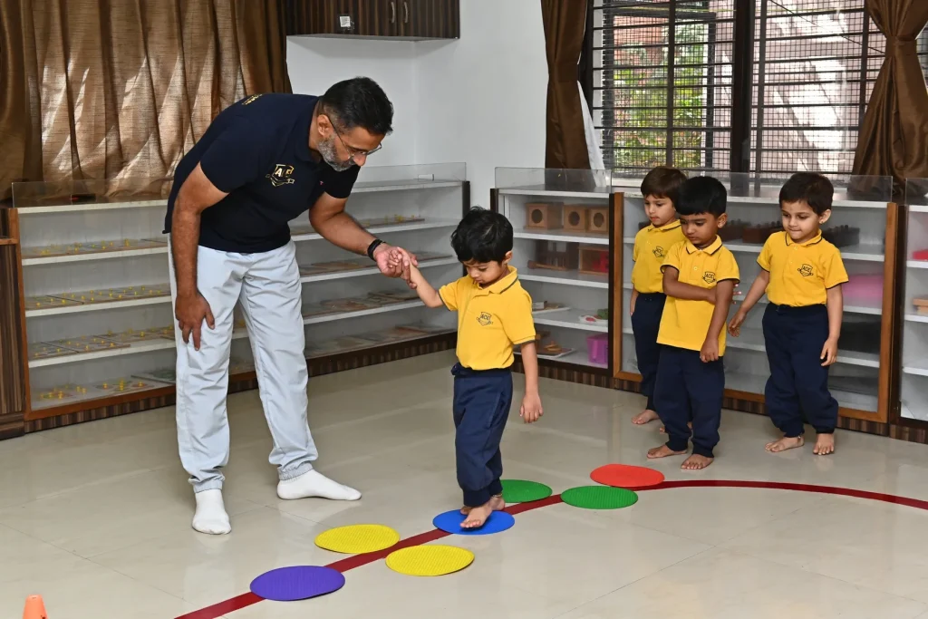 Teacher playing with children at ACE Montessori, Padmanabhanagar and Jayanagar, Bangalore
