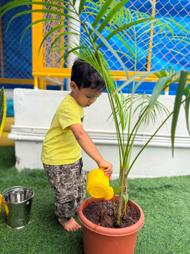 Child caring for plants at ACE Montessori, Jayanagar, Bangalore