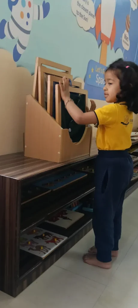Child with letter boards, Montessori classroom in Padmanabhanagar